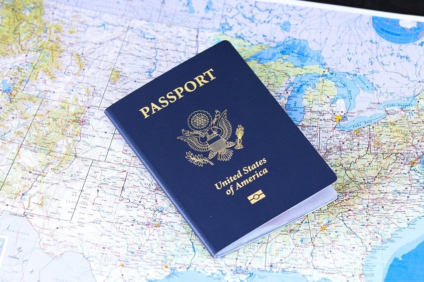 A passport sitting on top of a map